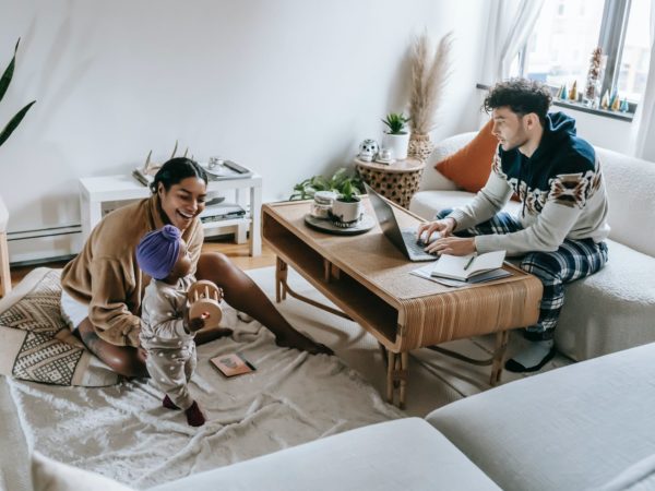 diverse family with black baby in room with laptop